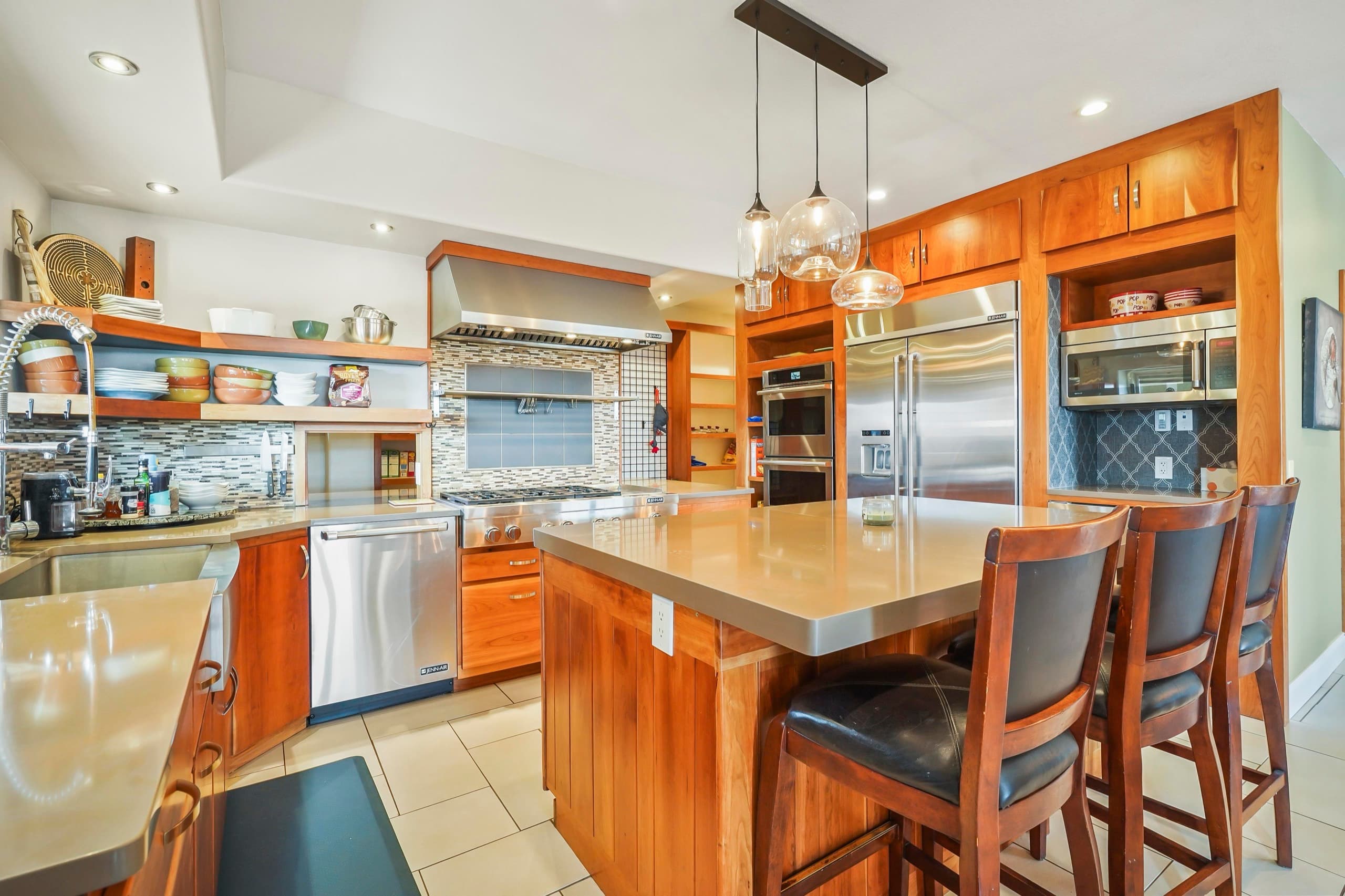 One of two full kitchens, with a chef's range, double ovens, and an island the cooks gather around